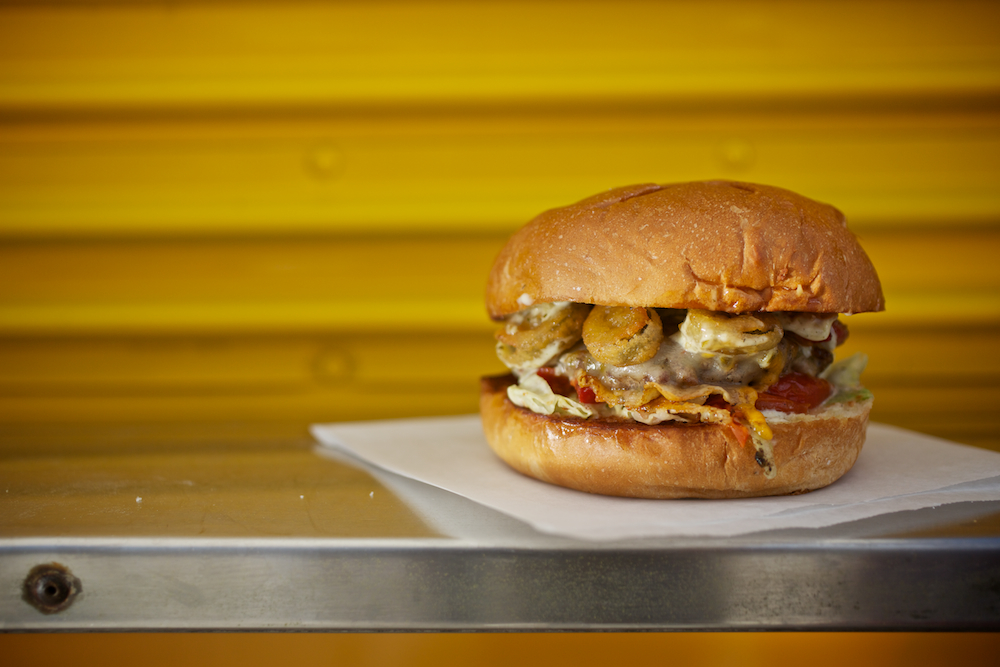 Burger on a yellow wall